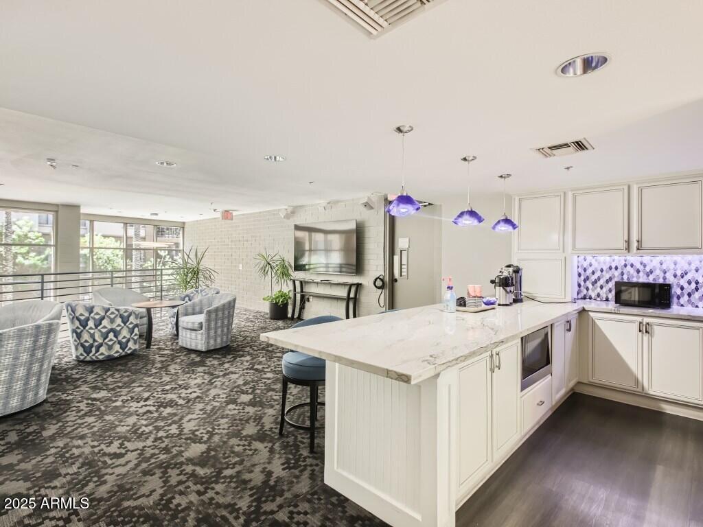 1701 East Colter Street, Unit 370 Phoenix, AZ 85016 - Photo 17 of 20 a large white kitchen with a stove a sink and dishwasher