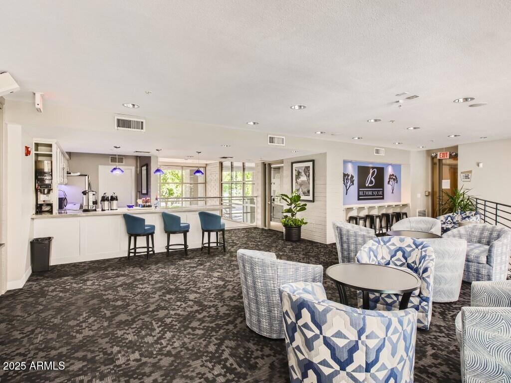 1701 East Colter Street, Unit 370 Phoenix, AZ 85016 - Photo 18 of 20 a living room with furniture a dining table and chairs with kitchen view