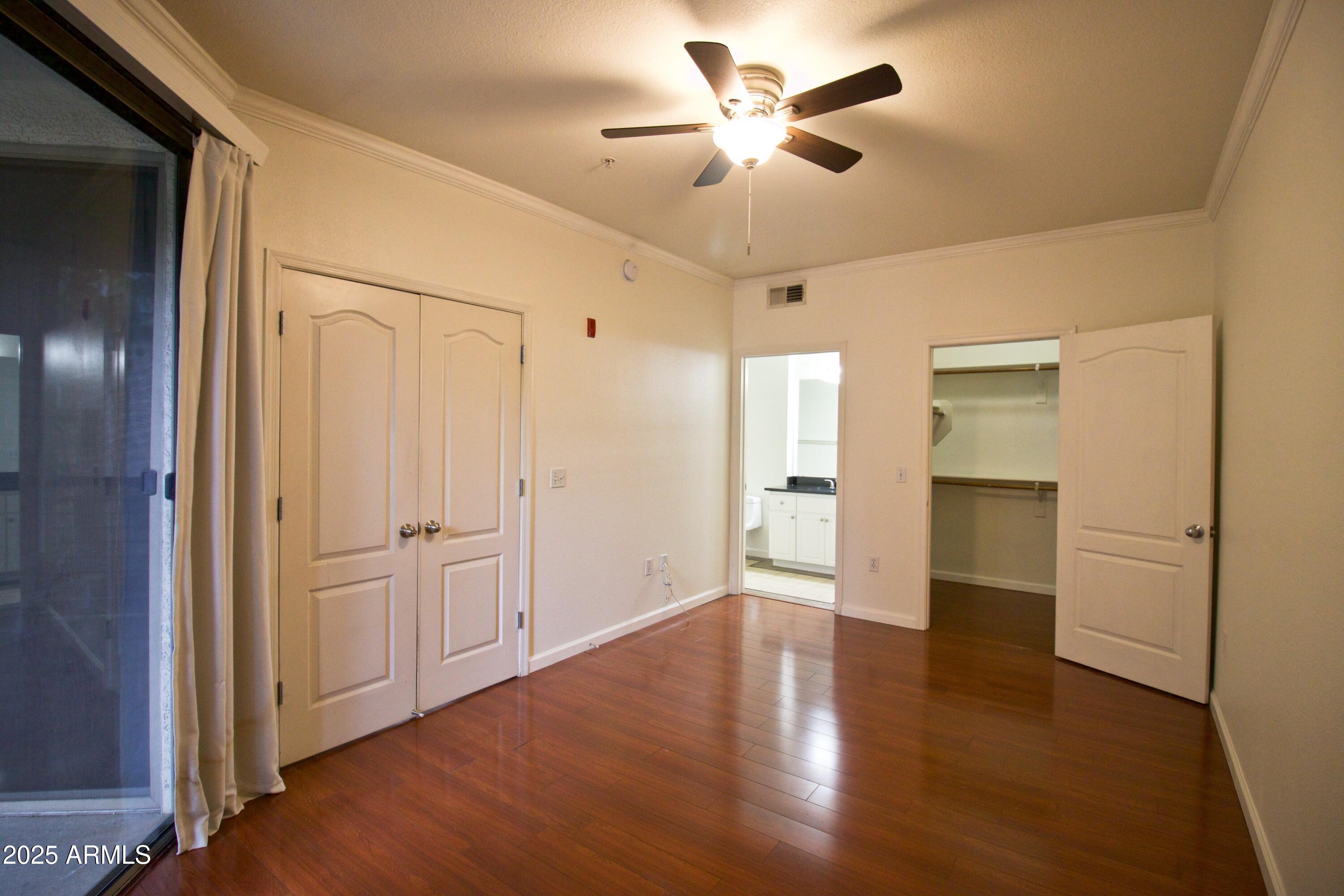 1701 East Colter Street, Unit 370 Phoenix, AZ 85016 - Photo 5 of 20 a view of an empty room with wooden floor and a window