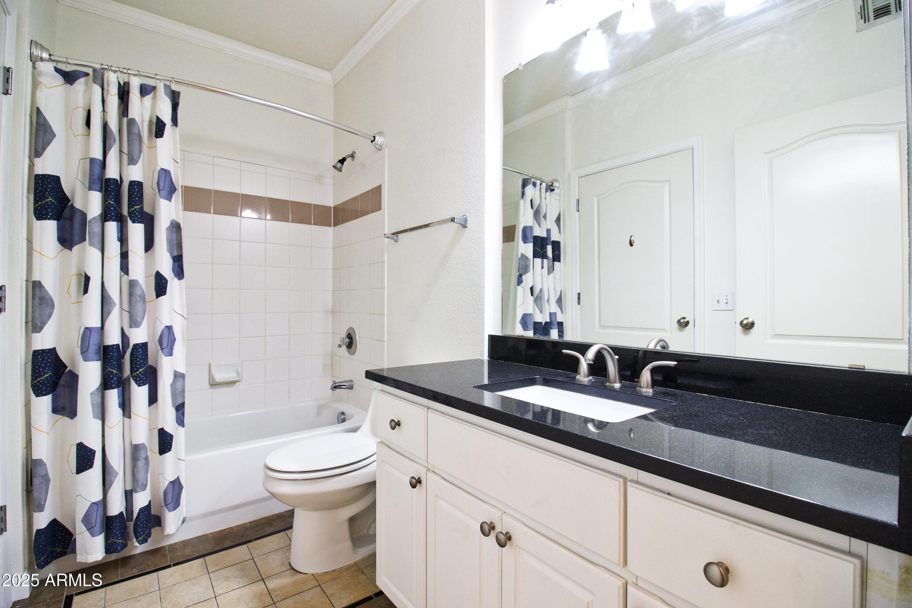 1701 East Colter Street, Unit 370 Phoenix, AZ 85016 - Photo 9 of 20 a bathroom with a granite countertop sink and a mirror