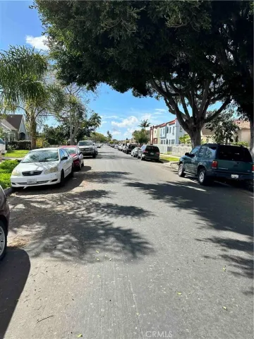 a view of street with parked cars