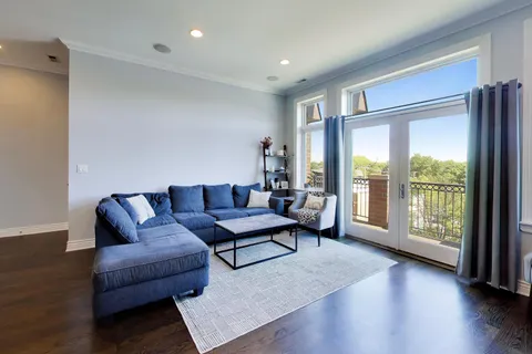 a living room with furniture a rug and a dining table