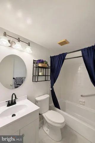 a bathroom with a sink a toilet and a mirror