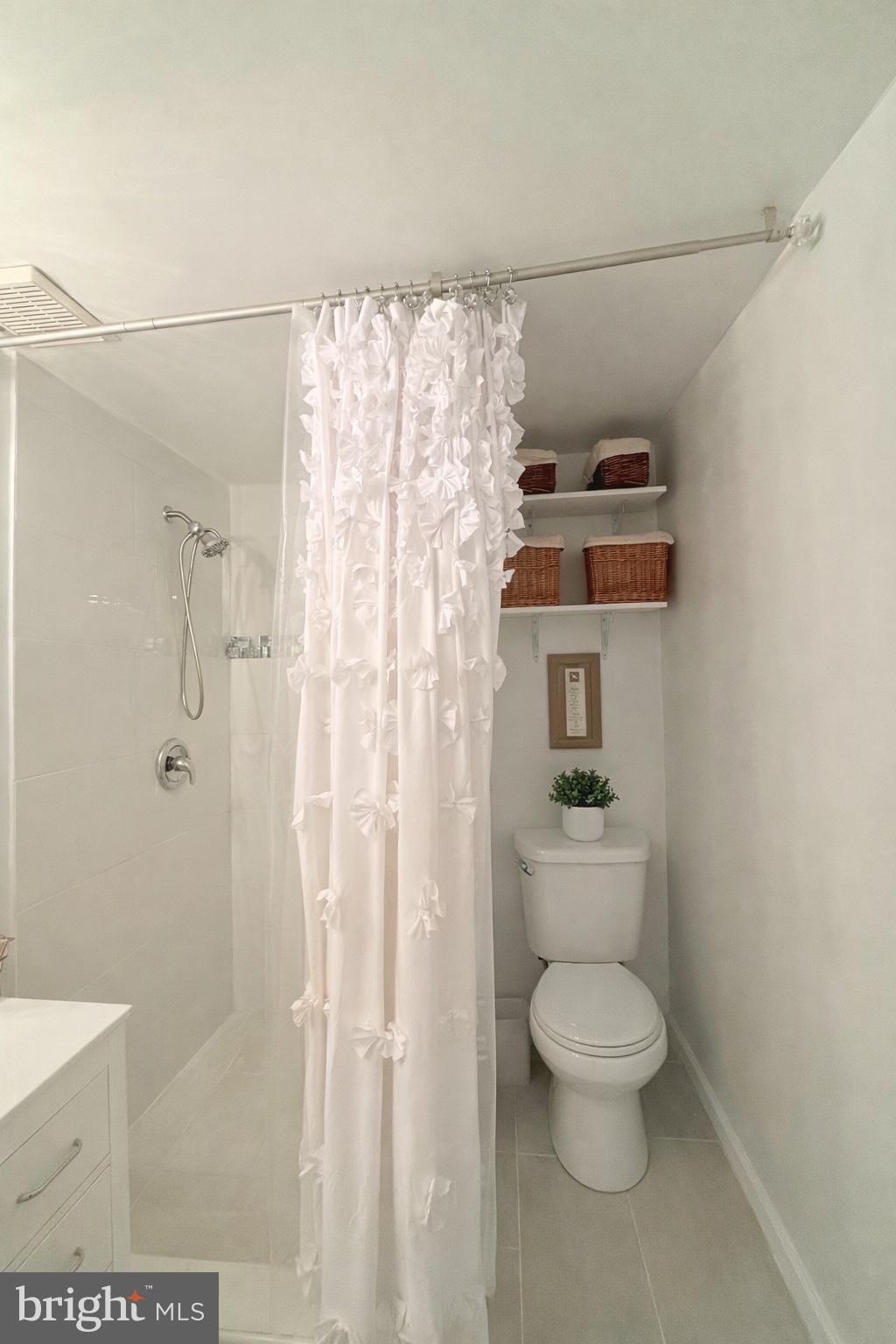 6915 Bugledrum Way Columbia, MD 21045 - Photo 15 of 25 a white toilet sitting next to a bathroom sink