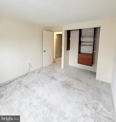 a view of an empty room with a closet