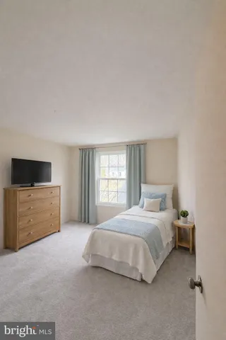 a bedroom with a bed and a television