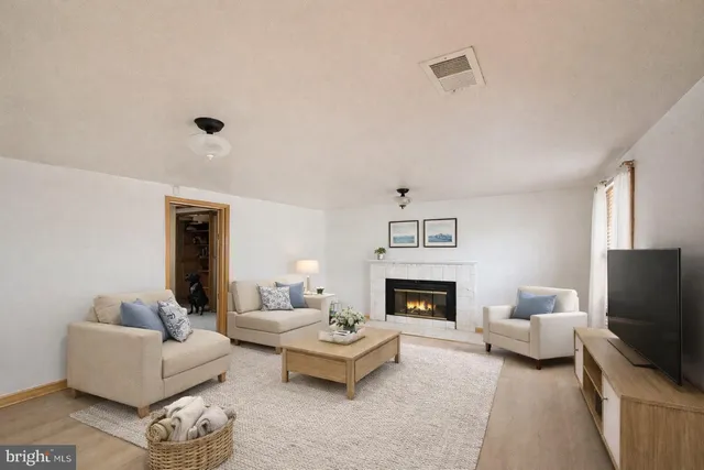 a living room with furniture flat screen tv and a fireplace