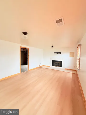 a view of empty room with a fireplace