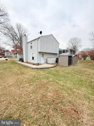a view of a house with a yard and sitting area
