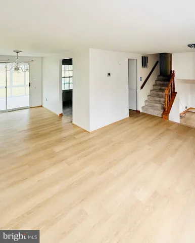 a view of an empty room with stairs and ventilation