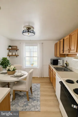 a kitchen with a table chairs stove and cabinets