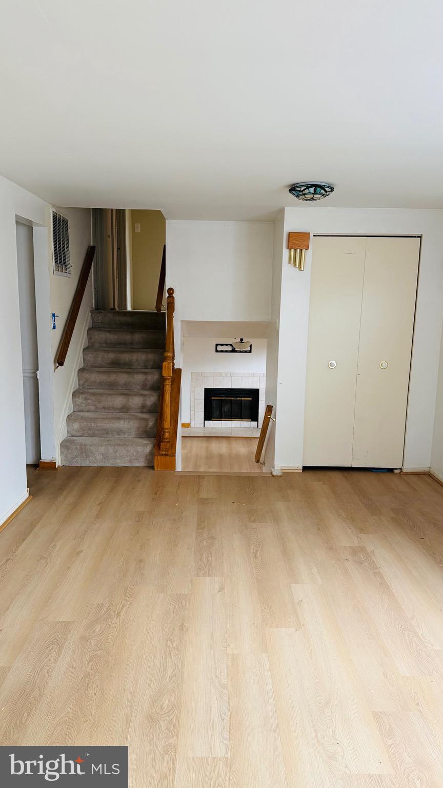 6915 Bugledrum Way Columbia, MD 21045 - Photo 10 of 25 a view of an empty room with fireplace and a window
