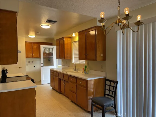 a bathroom with a double vanity sink a large mirror and a bathtub