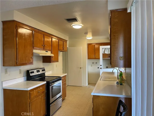 a kitchen with a stove a sink and a refrigerator