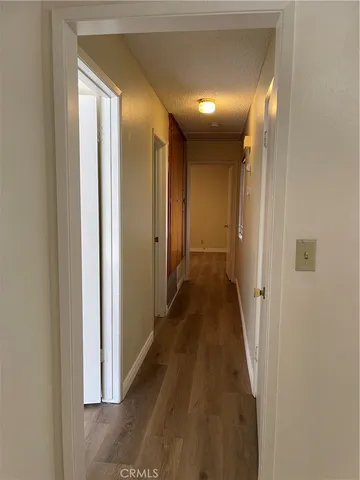 a view of a hallway with wooden floor