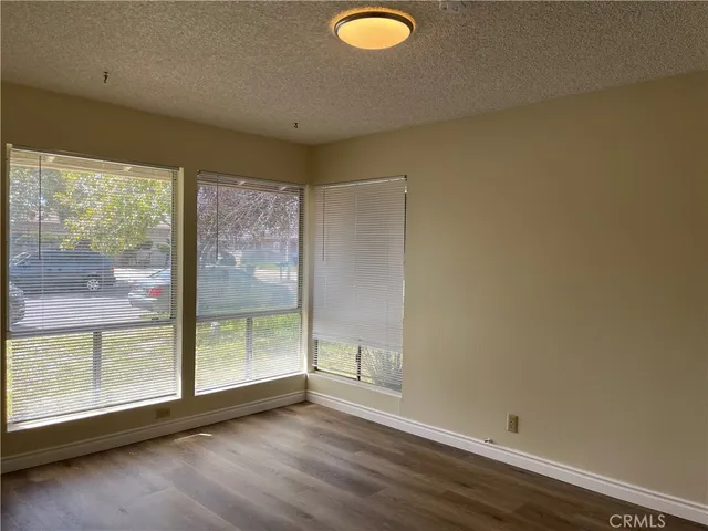 a bathroom with a granite countertop sink a toilet and mirror