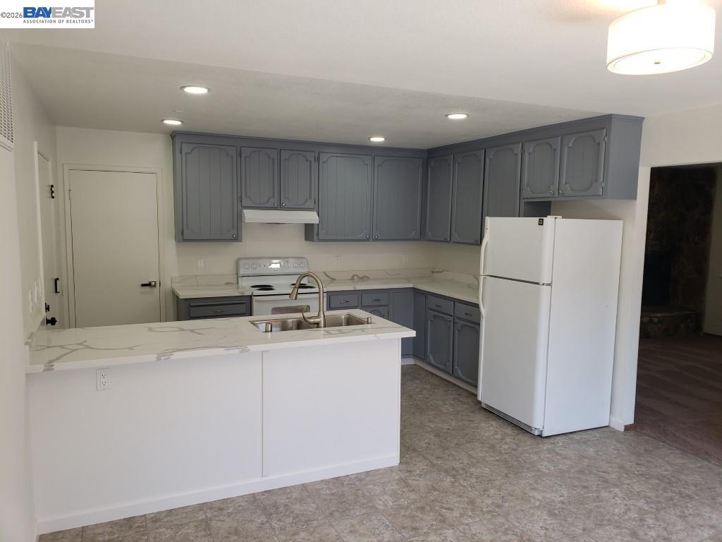 342 Washington Boulevard, Unit 342 Fremont, CA 94539 - Photo 3 of 12 a kitchen with a refrigerator sink stove and cabinets