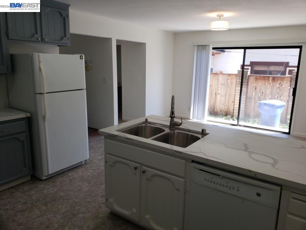 342 Washington Boulevard, Unit 342 Fremont, CA 94539 - Photo 8 of 12 a kitchen with a refrigerator and a sink