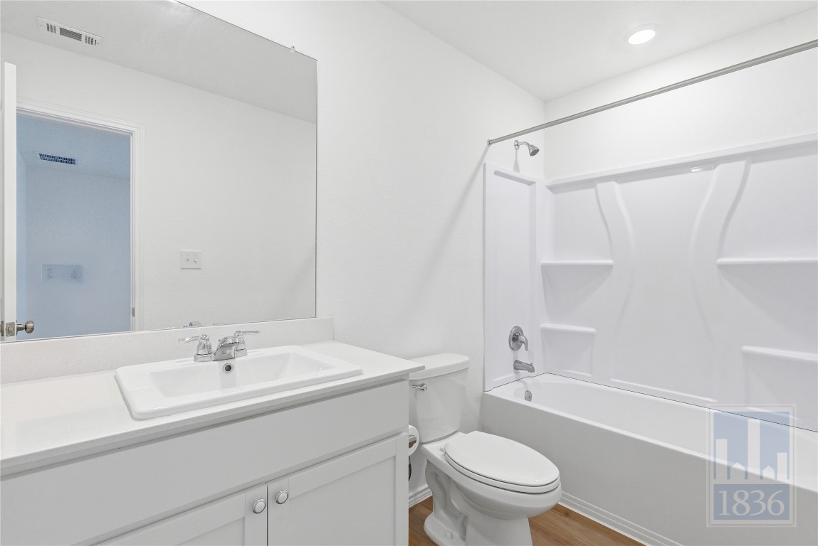 2213 Cyclone Drive Lockhart, TX 78644 - Photo 12 of 26 a bathroom with a sink a toilet and a mirror