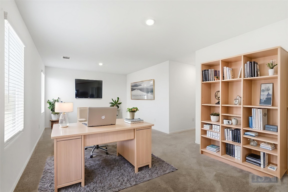 2213 Cyclone Drive Lockhart, TX 78644 - Photo 15 of 26 a workspace with furniture and a bookshelf