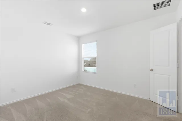 a view of an empty room and a window