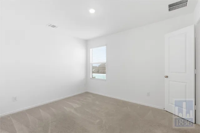 a view of an empty room and a window