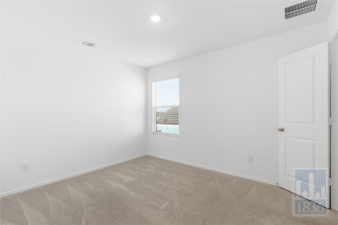 2213 Cyclone Drive Lockhart, TX 78644 - Photo 17 of 26 a view of an empty room and a window