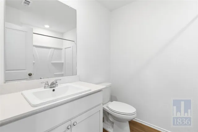 a bathroom with a sink toilet and a mirror