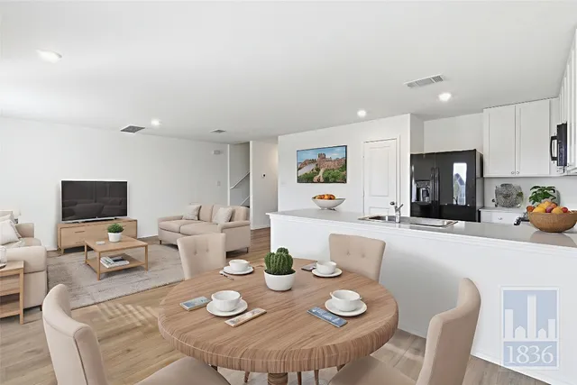 a open dining room with furniture a window and kitchen view