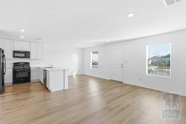 a view of kitchen with sink microwave and stove