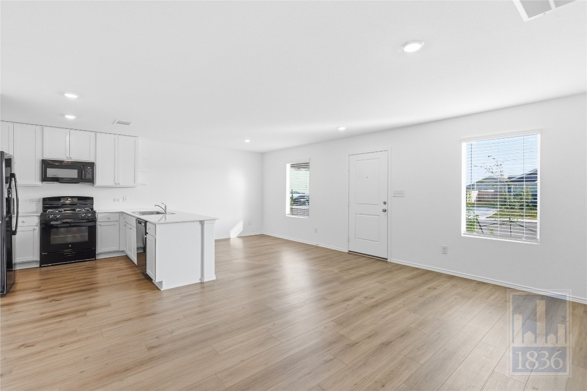 2213 Cyclone Drive Lockhart, TX 78644 - Photo 5 of 26 a view of kitchen with sink microwave and stove
