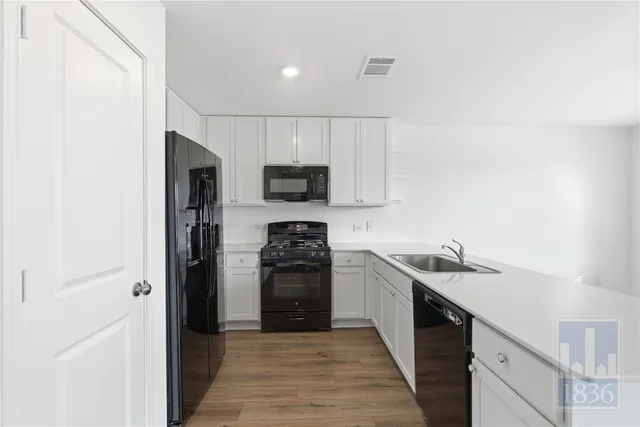 a kitchen with a sink a stove and refrigerator