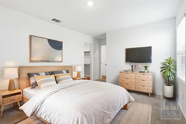 a bedroom with a bed and a flat screen tv