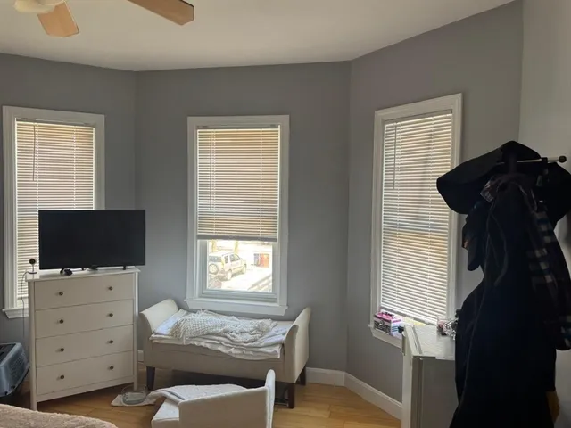 a bedroom with a bed and flat tv screen