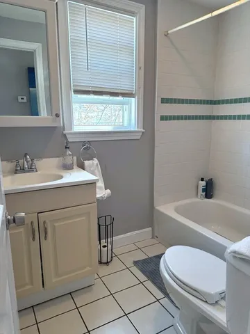 a bathroom with a sink toilet vanity and tub