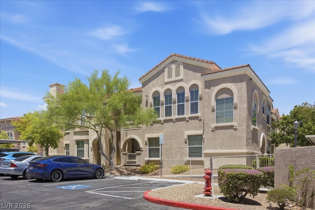 10550 West Alexander Road, Unit 2164 Las Vegas, NV 89129 - Photo 2 of 27 Architectural arches and intricate detailing adorn this inviting multi-level stucco building.