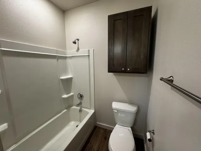 a bathroom with a toilet sink and shower