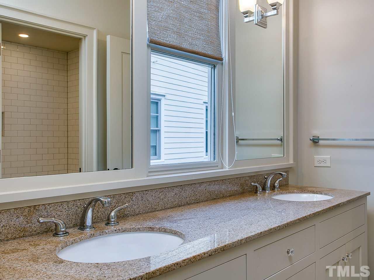 506 Wayne Drive Raleigh, NC 27608 - Photo 22 of 25 a bathroom with a granite countertop sink and a mirror