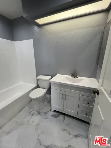 a bathroom with a double vanity sink toilet and shower
