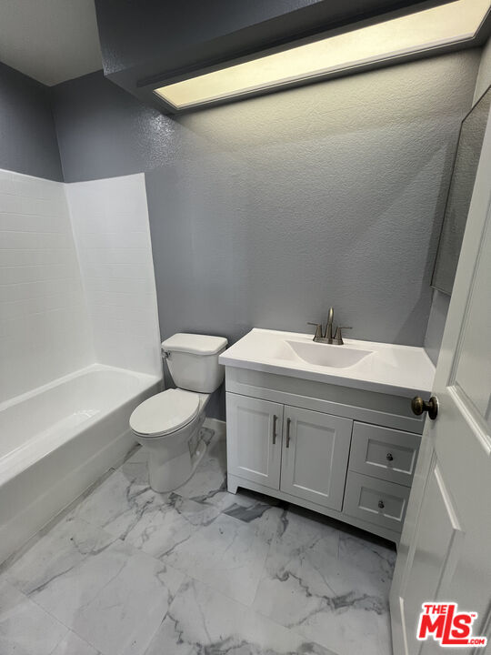 7639 Kester Avenue, Unit 5 Van Nuys, CA 91405 - Photo 14 of 21 a bathroom with a double vanity sink toilet and shower