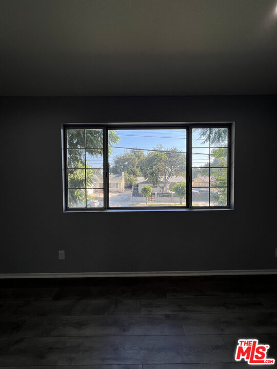 7639 Kester Avenue, Unit 5 Van Nuys, CA 91405 - Photo 21 of 21 a living room with a black gate next to a window