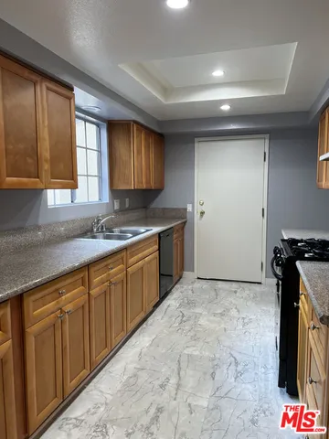 a kitchen with stainless steel appliances granite countertop a sink stove and granite counter top