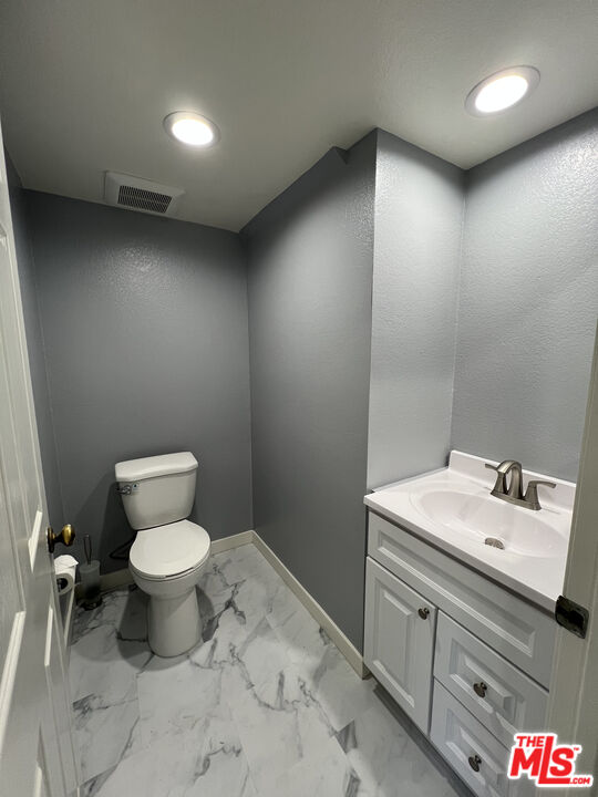 7639 Kester Avenue, Unit 5 Van Nuys, CA 91405 - Photo 7 of 21 a bathroom with a toilet sink and mirror