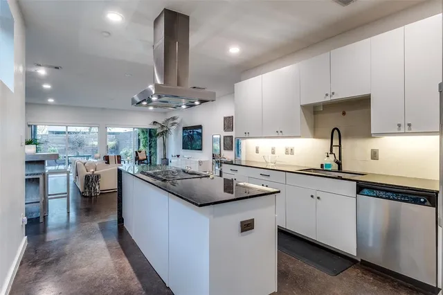 a kitchen with stainless steel appliances a sink stove and cabinets