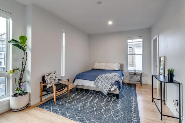 a bedroom with a bed and a potted plant