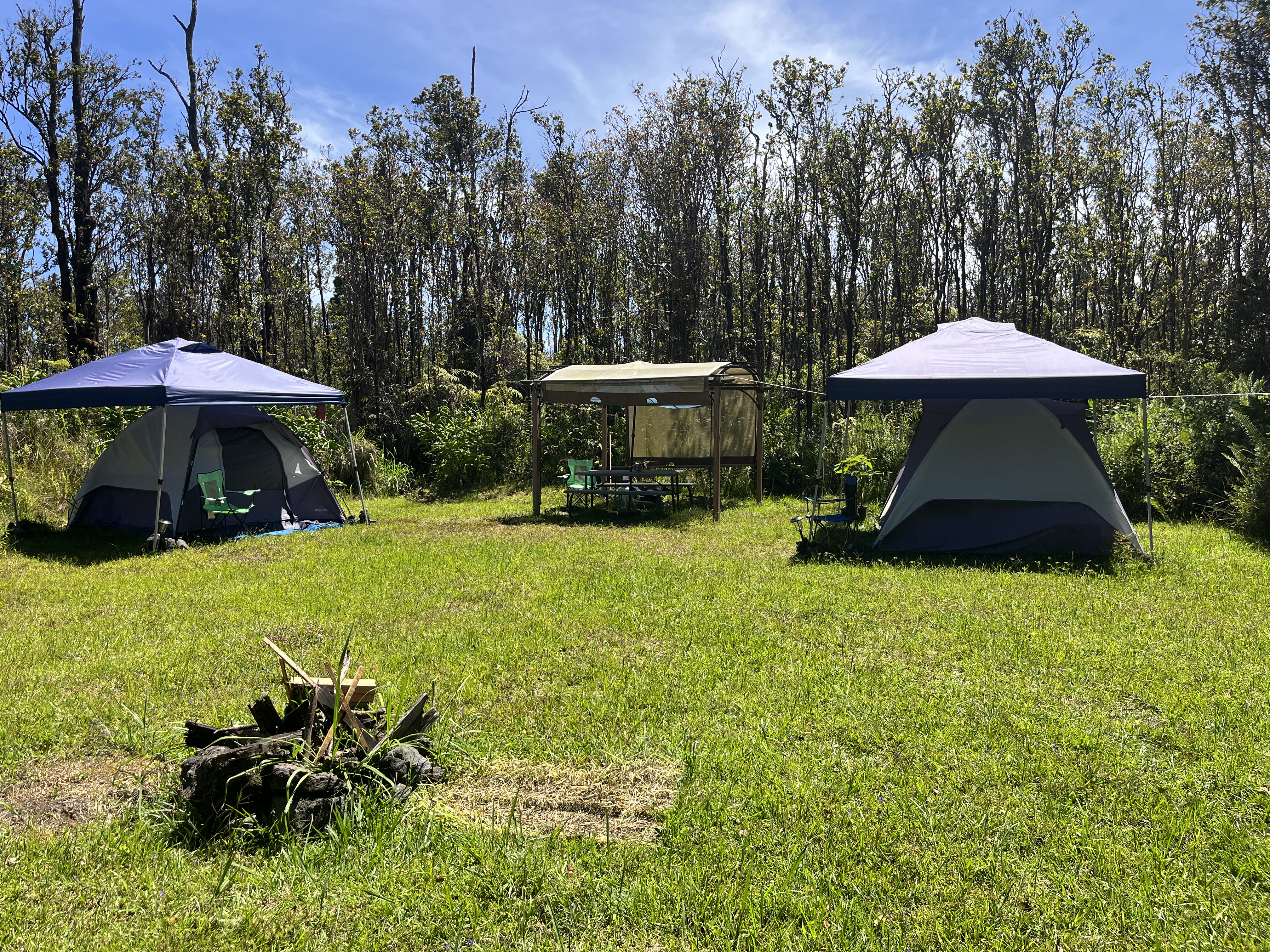 11-2729 Uakoko Road Mountain View, HI 96771 - Photo 23 of 26 a view of a swimming pool with a table and chairs under an umbrella