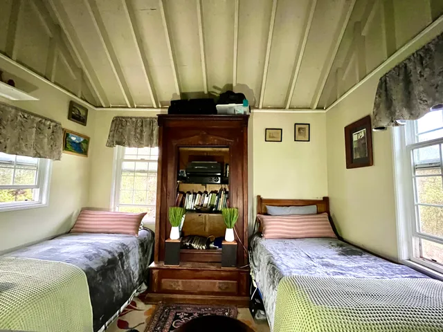 a bedroom with a bed a window with the outer view