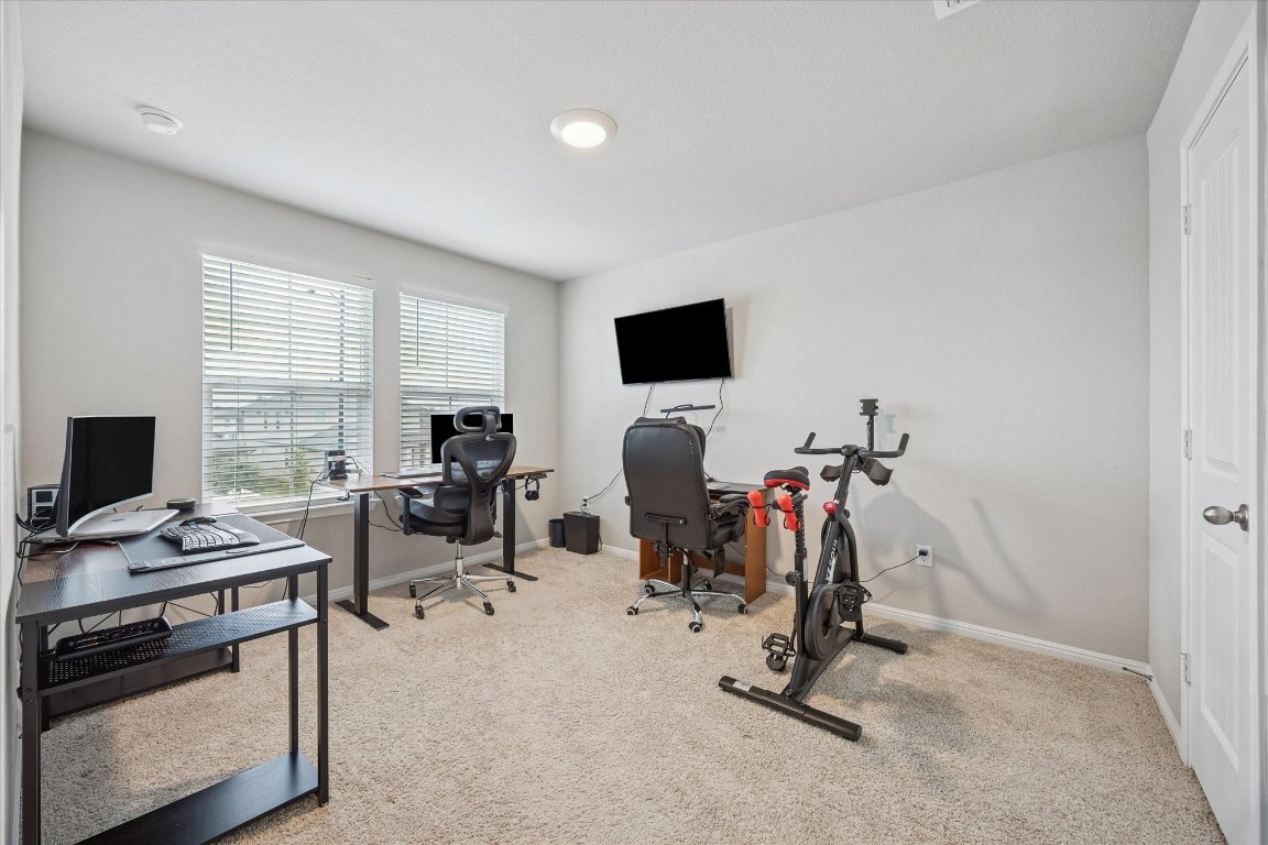 724 Aster Place Bastrop, TX 78602 - Photo 13 of 16 a view of a workspace with furniture and a window