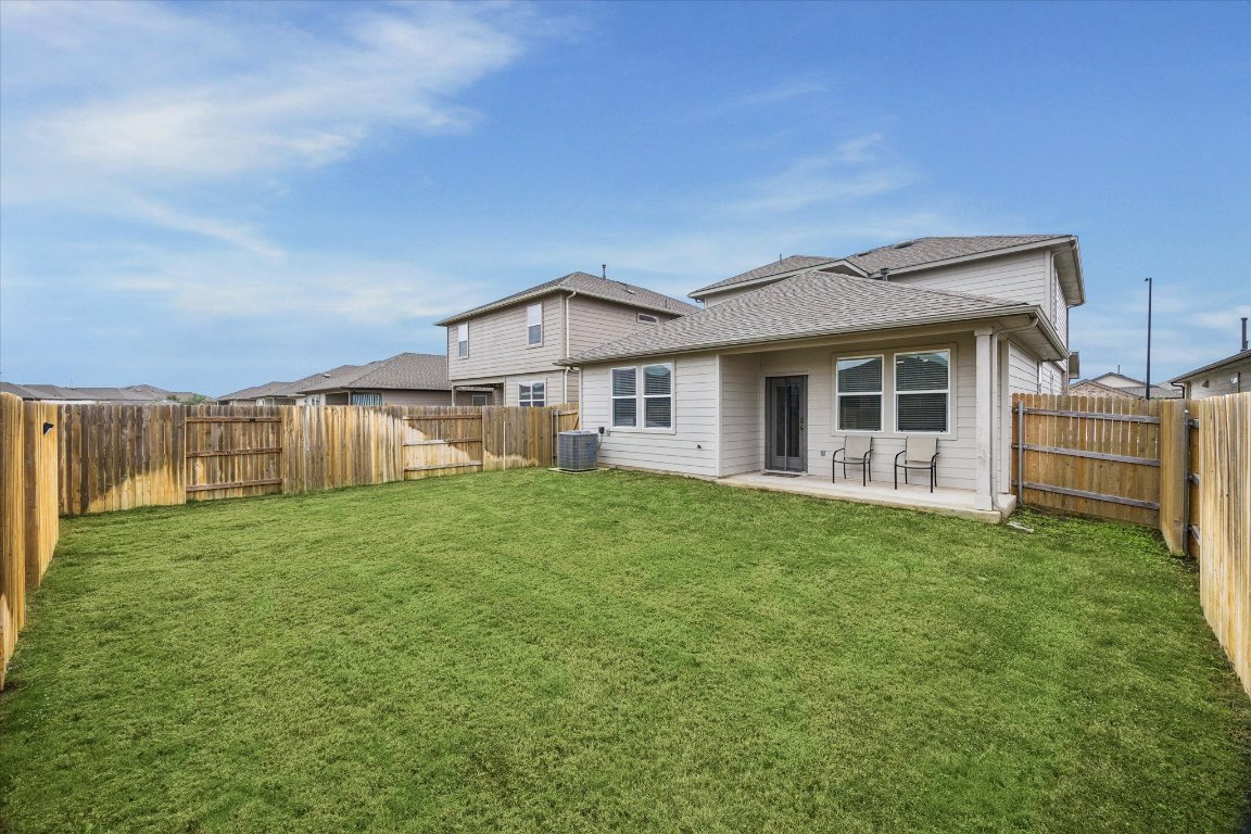 724 Aster Place Bastrop, TX 78602 - Photo 16 of 16 a view of a house with a backyard