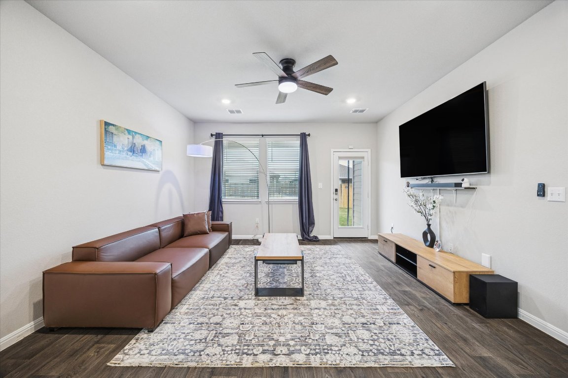 724 Aster Place Bastrop, TX 78602 - Photo 6 of 16 a living room with furniture and a flat screen tv